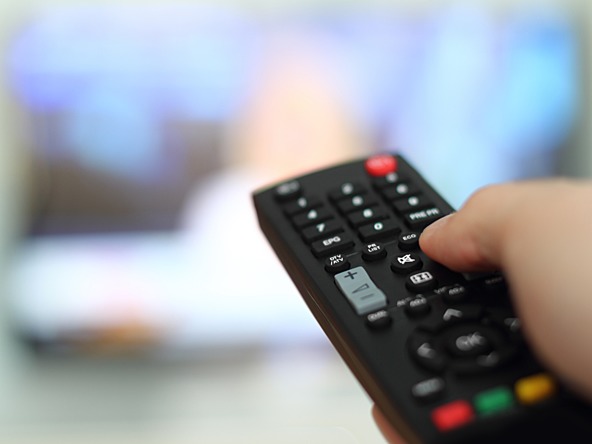 Person using a TV remote control